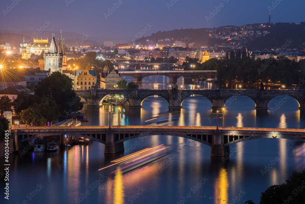 Vltava River and Prague cityscape at sunset.