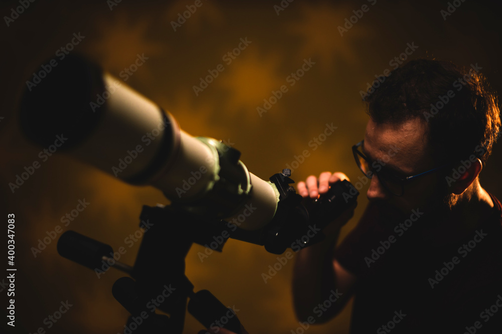 Fototapeta premium Amateur astronomer looking at the stars with a telescope. Astronomy and astrology concept.