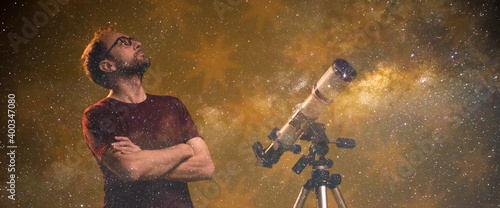 Amateur astronomer looking at the stars with a telescope. Astronomy and astrology concept. © astrosystem