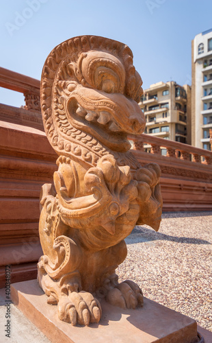 Angled view of Dragon statue, an Indonesian sculpture, in front of Baron Empain Palace, a historic mansion inspired by the Cambodian Hindu temple of Angkor Wat, Heliopolis district, Cairo, Egypt photo