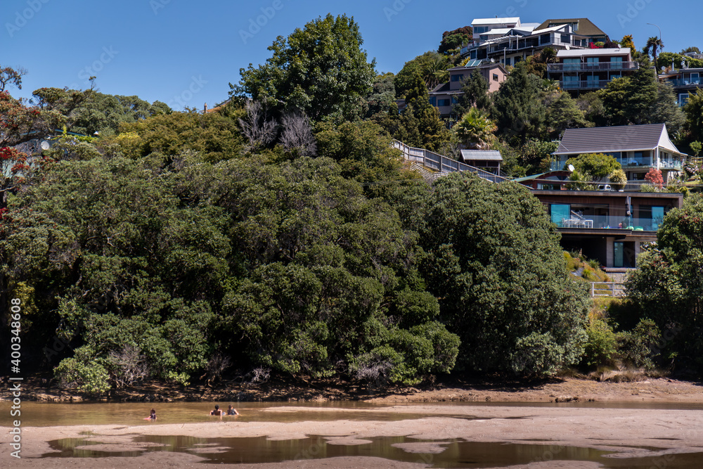 houses on a hill next to a dried up river