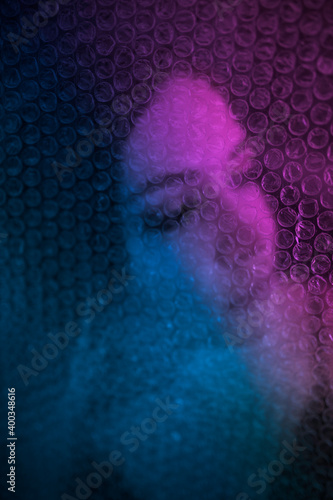 Duotone woman portrait thru wrap bubble plastic