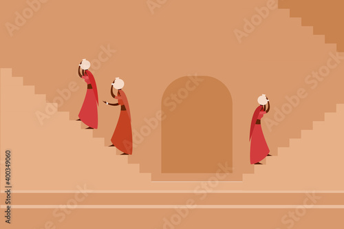 Fototapeta Women carrying water pots on their heads fetching water from a step well