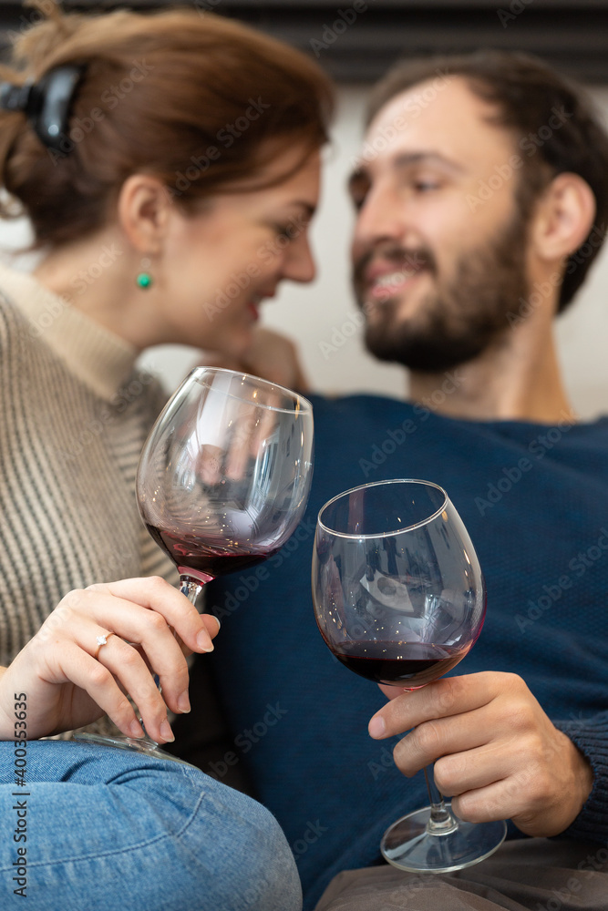 Young and happy couple drinking wine and relaxing at home Young and happy couple drinking wine and relaxing at home