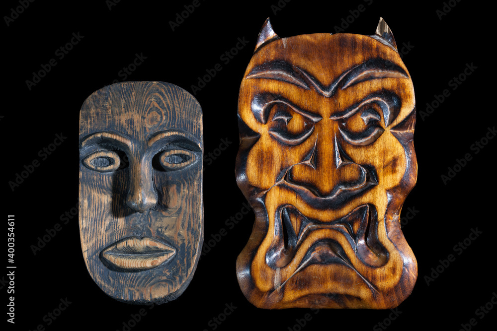 Masks carved from wood on a black background. African mask and the mask trait