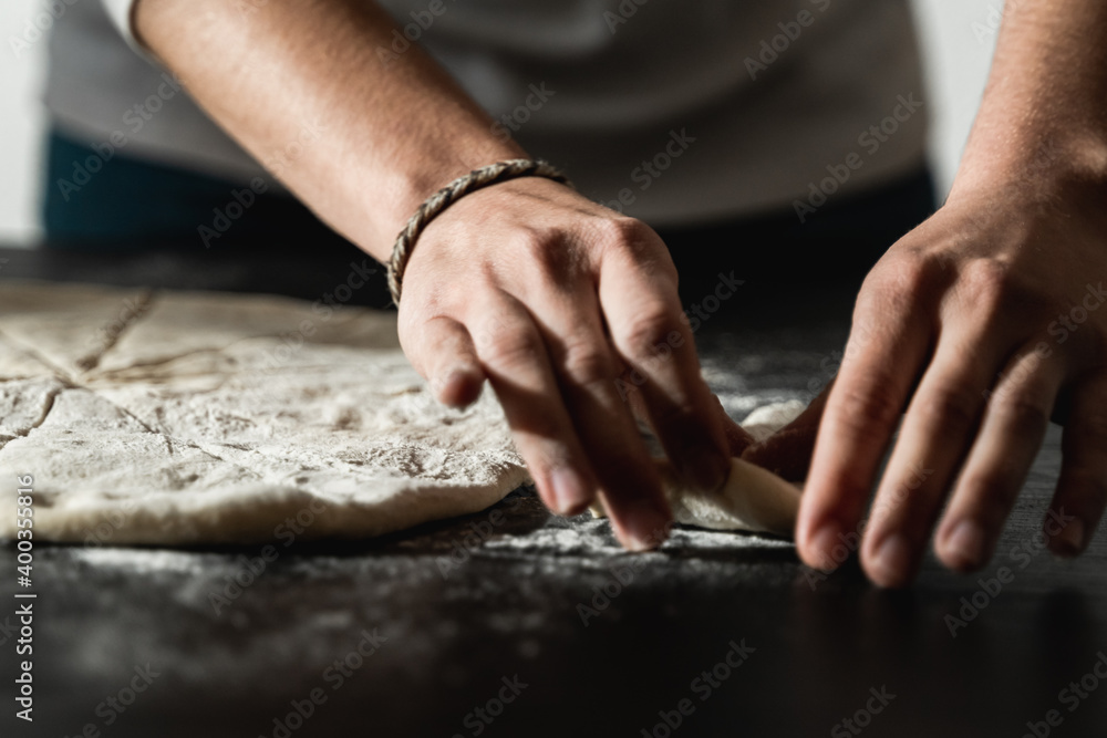 Young baker preparing dough for pizza at home - Homemade food concept Young baker preparing dough for pizza at home - Homemade food concept