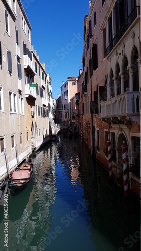 Beautiful narrow canal with silky water in Venice  Italy