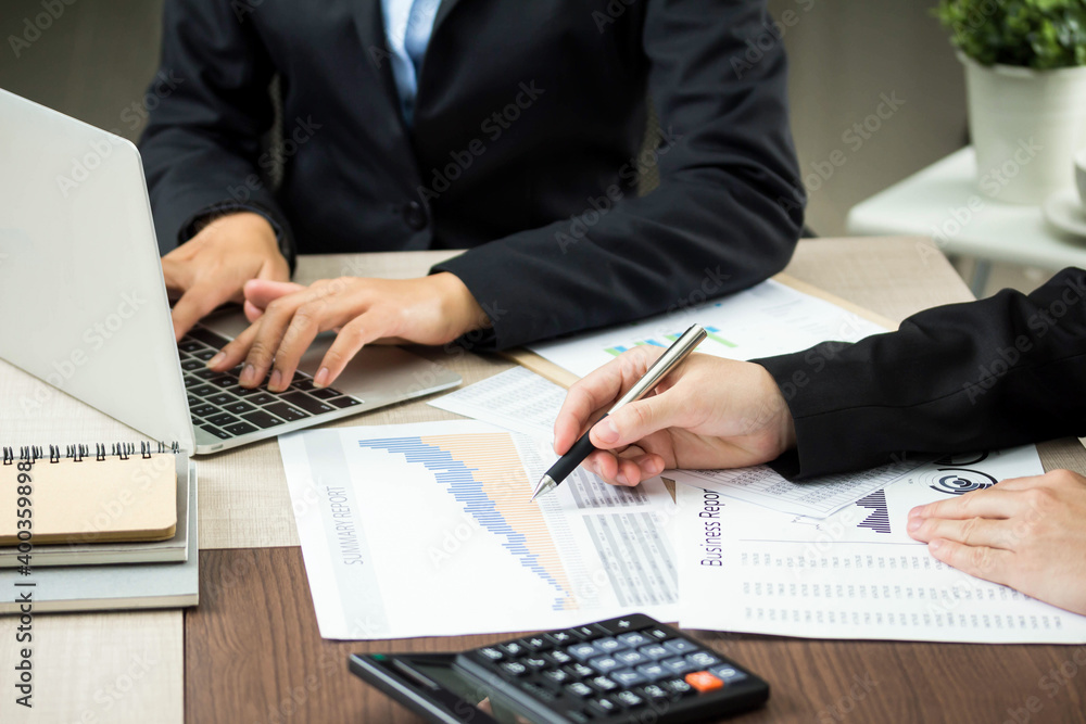 Accountant using calculator for checking numbers from balance sheet and financial statement. Concept of internal audit, accounting. Accountant using calculator for checking numbers from balance sheet and financial statement. Concept of internal audit, accounting.