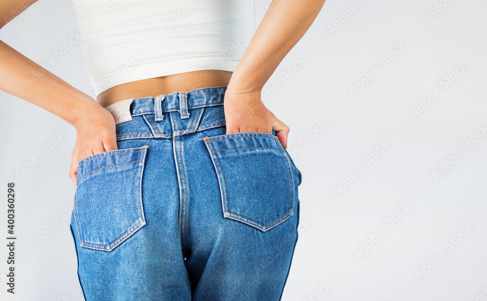 Fit shape Woman wearing of body jeans pants from back. Female