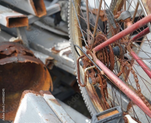 A bicycle very rusts on a steels storage which out of the building. photo