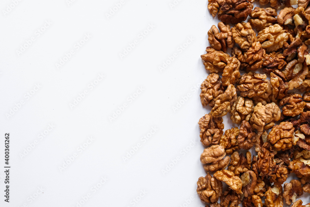 Obraz premium Top view of peeled walnuts placed on a white