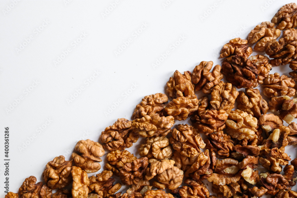 Top view of peeled walnuts placed on a white Top view of peeled walnuts placed on a white