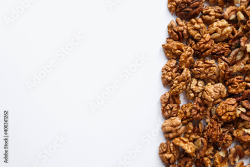 Top view of peeled walnuts placed on a white