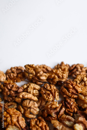 Top view of peeled walnuts placed on a white