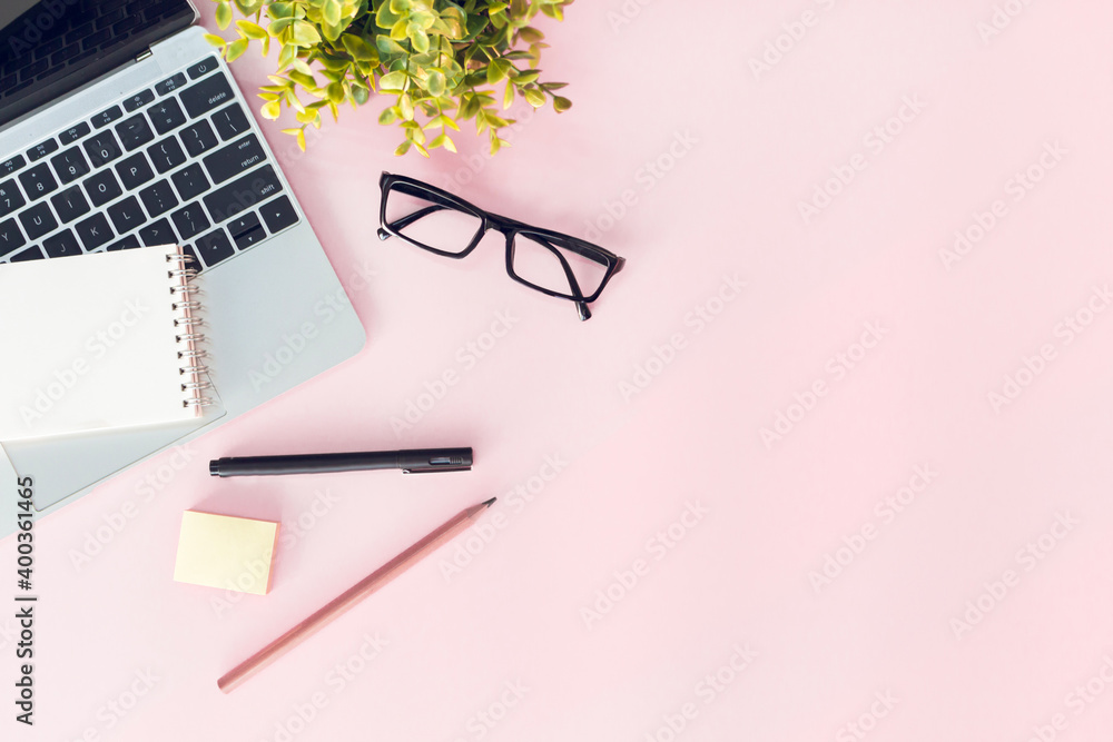 Modern pink office desk table with notebook for input the text in the middle. Top view, flat lay Modern pink office desk table with notebook for input the text in the middle. Top view, flat lay