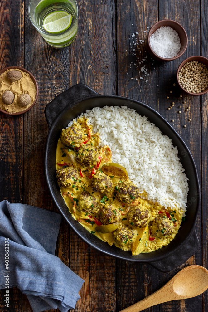 Meatballs with rice, curry sauce, lime and red pepper. Healthy eating. Meatballs with rice, curry sauce, lime and red pepper. Healthy eating.