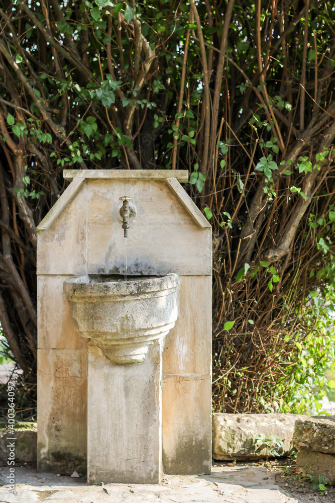 old water fountain, made in nature so that passers-by can rest and refresh themselves with drinking water old water fountain, made in nature so that passers-by can rest and refresh themselves with drinking water