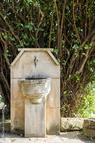 old water fountain  made in nature so that passers-by can rest and refresh themselves with drinking water