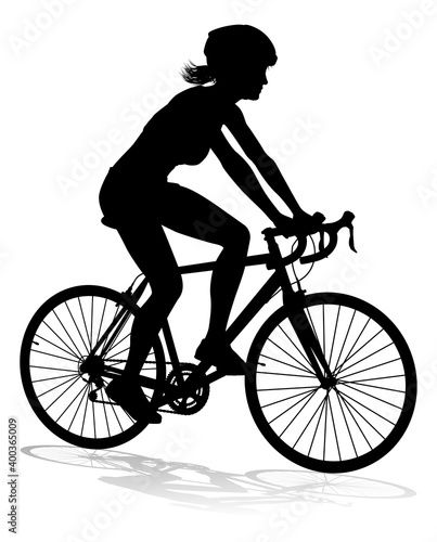 Bicyclist riding their bike and wearing a safety helmet in silhouette