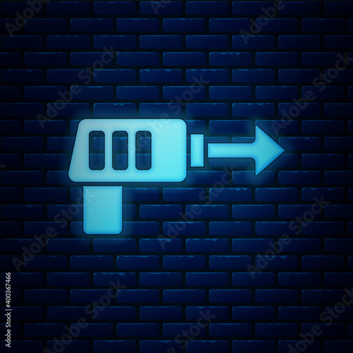 Glowing neon Fishing harpoon icon isolated on brick wall background. Fishery manufacturers for catching fish under water. Diving underwater equipment.  Vector.