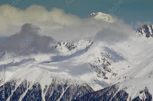 Winter landscape with mountain peaks, gorges, deep snow cover, ski slopes. © Михаил Рафибеков