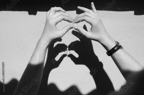 Funny wedding photography. The sun shadow from the hands of the groom with the rings becomes like two hares and a monster. Interesting idea, lifestyle, poster, card. photo