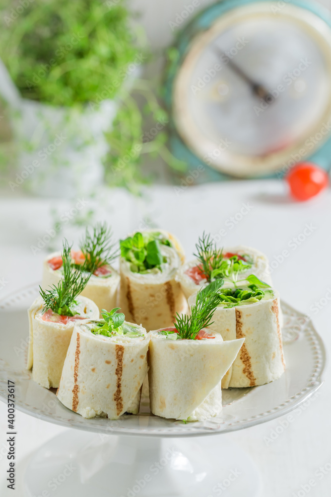 Tasty tortilla with salmon, creamy cheese and vegetables Tasty tortilla with salmon, creamy cheese and vegetables