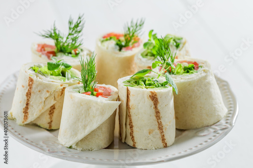 Tortilla with salmon, creamy cheese and vegetables