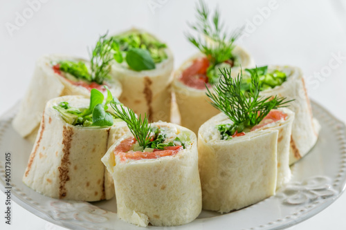 Closeup of tortilla with vegetables, herbs and cheese