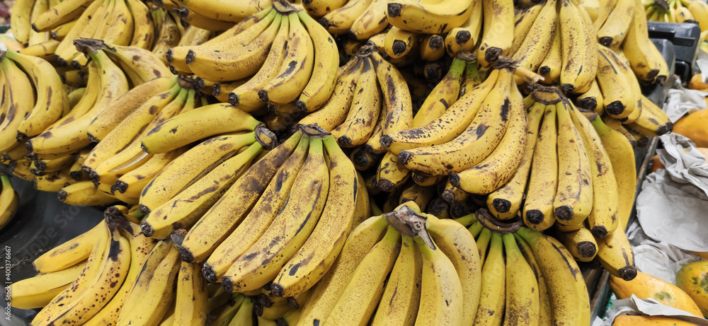 Bananas for sale in a supermarket gondola.