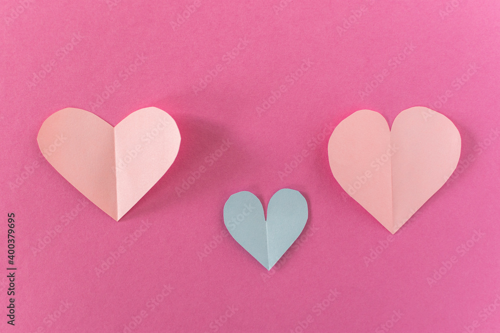 Paper pastel pink hearts on a pink background. the concept of romance, love and tenderness. Bright greeting card for Valentine's Day. Design of the anniversary of mother's Day. The view from the toss.