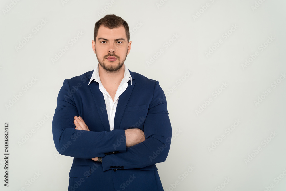 Close up of young business man in a suit with crossed arms on a white background Close up of young business man in a suit with crossed arms on a white background