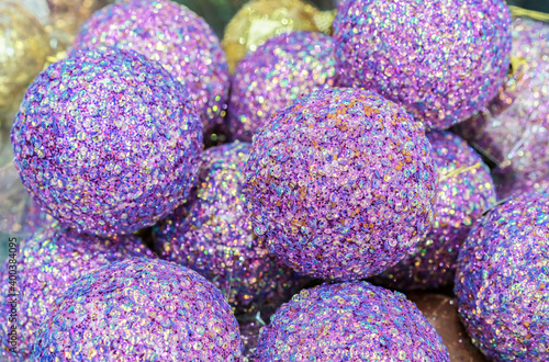 Lilac Christmas balls with payettes. Background with shiny Christmas balls. photo