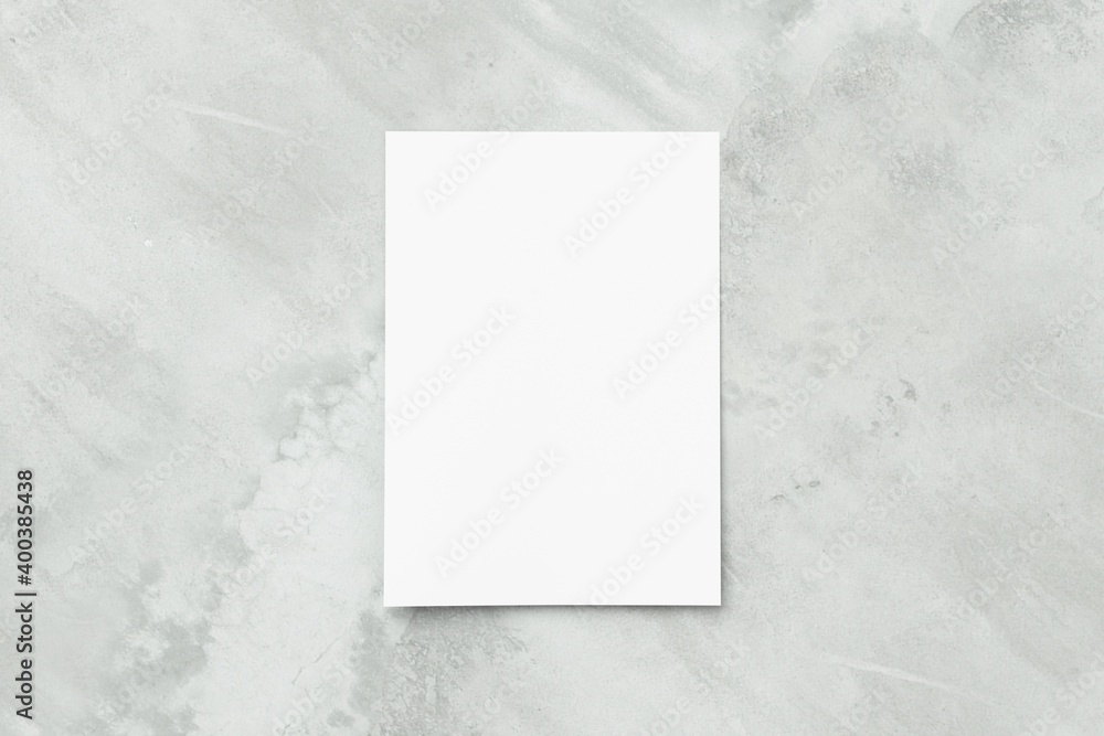 Blank white A4 paper sheet on concrete floor Blank white A4 paper sheet on concrete floor