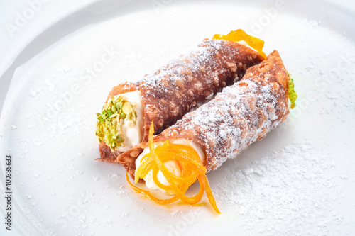 Italian dessert cannoli on a white plate, waffles with ricotta cheese photo