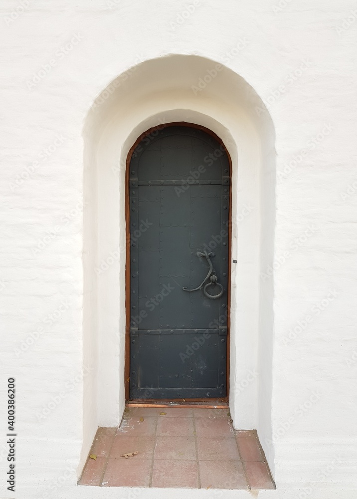 Fototapeta premium Antique iron door in a stone house