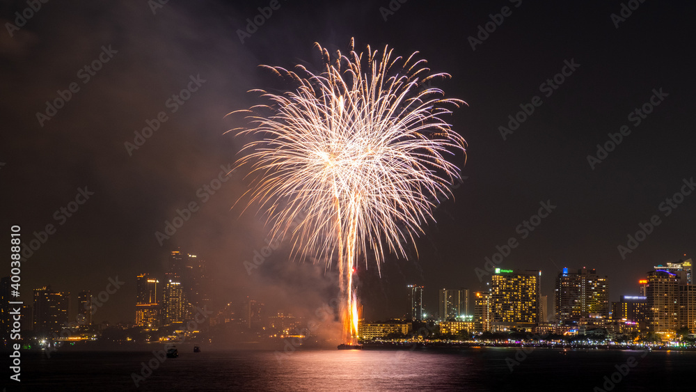 Beautiful colorful fireworks at night sky with city scape view on background.