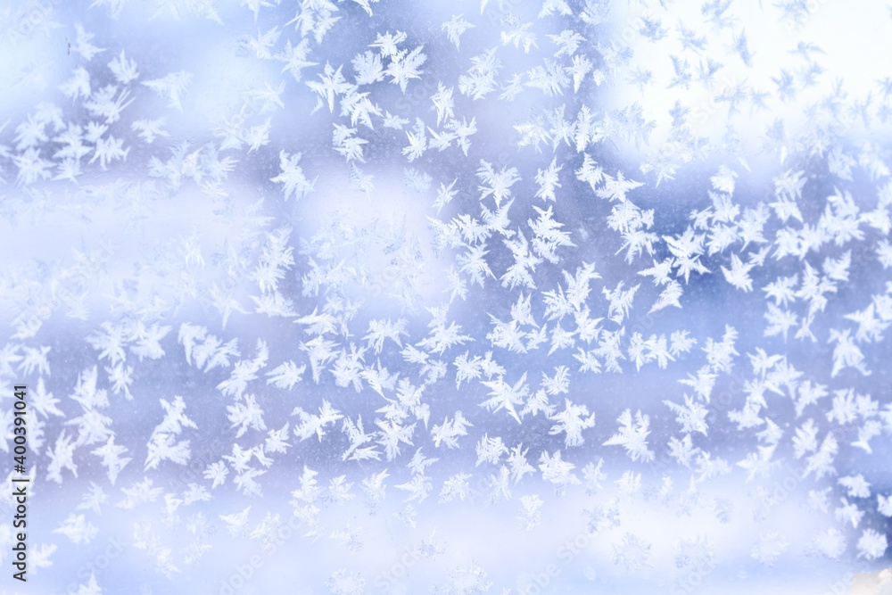 frozen snowflakes on glass on a blue background