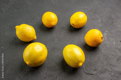front view fresh lemons lined on dark background citrus yellow fruit lime