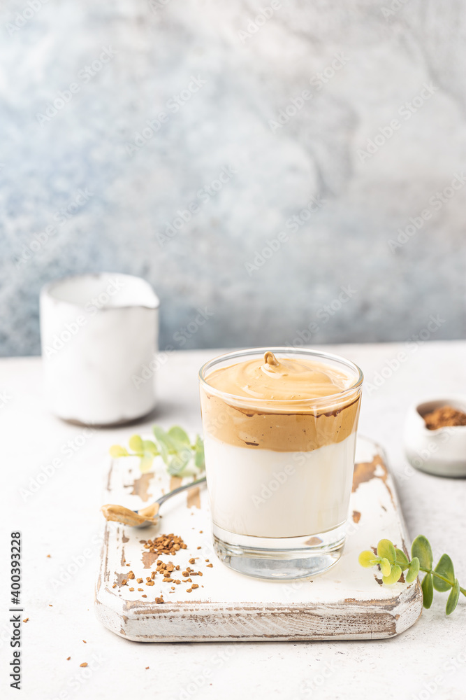Dalgona Coffee, a cool fluffy whipped coffee in a glass. Latte espresso with coffee foam in tall glass. Trendy drink Dalgona Coffee, a cool fluffy whipped coffee in a glass. Latte espresso with coffee foam in tall glass. Trendy drink