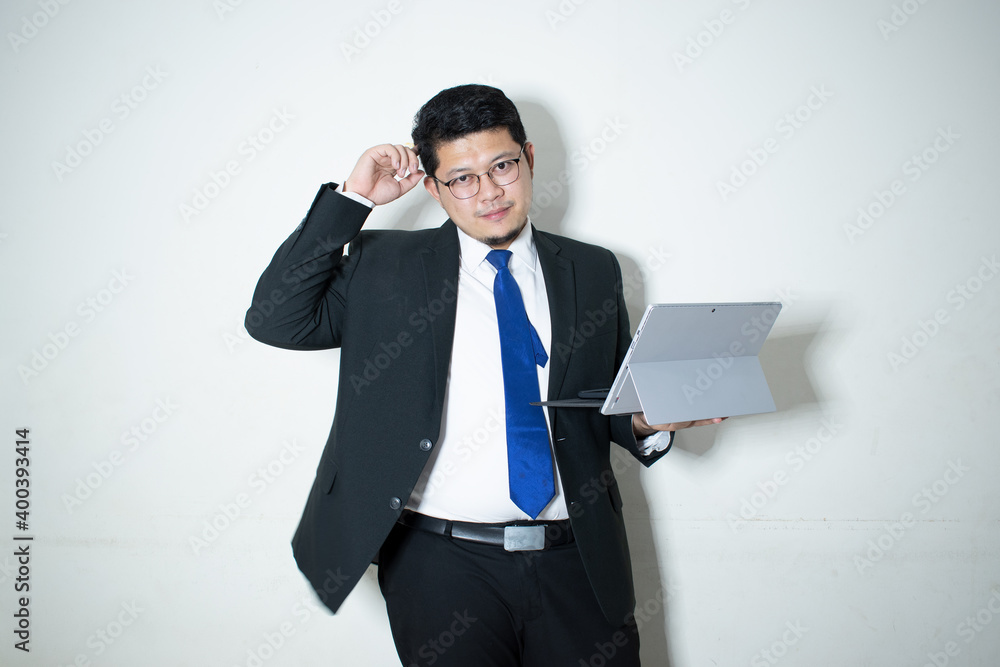 Happy young business man working on a laptop, isolated on white background Happy young business man working on a laptop, isolated on white background
