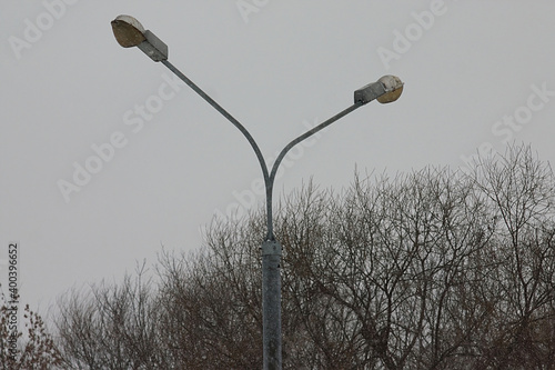 top of the pole with two lamps on a snowy day photo