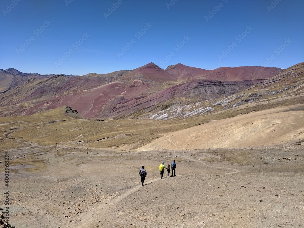 trekking through high alpine rainbow mountains in peru