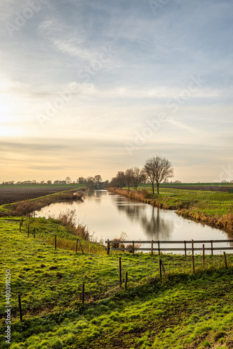 Fototapeta Naklejka Na Ścianę i Meble -  Picturesque Dutch landscape at the end of a sunny winter day. The photo was taken in the polder Hooge Nesse near the village of Heerjansdam, municipality of Zwijndrecht, province of South Holland.