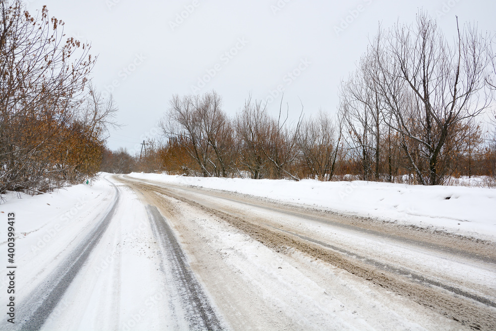 Fototapeta premium Snow-covered road in a snow-covered pine forest