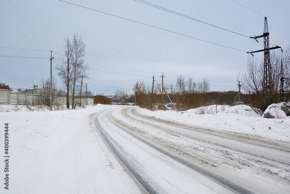 Snow-covered road in a snow-covered pine forest Snow-covered road in a snow-covered pine forest
