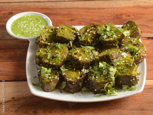 Patra or Alu Vadi or Alu wadi is a popular maharashtrian and Gujarati snack made using colocasia leaves, gram flour and flavourings spices, tamarind, and jaggery, steamed rolls, selective focus photo