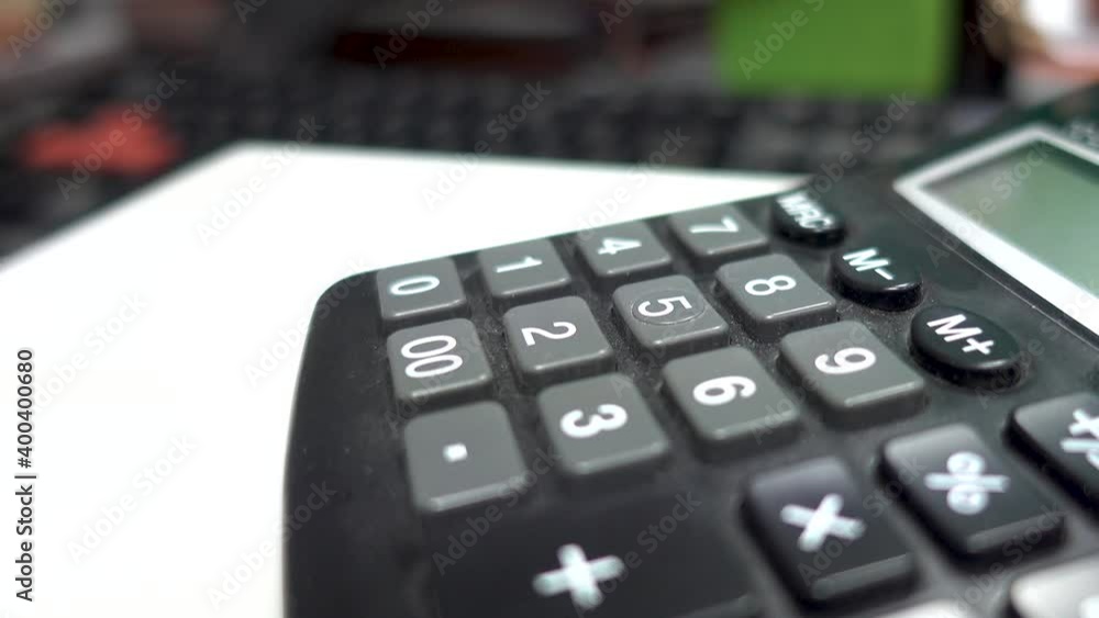 Horizontal video of young male using a calculator. Business accounting and financial concept. Calculating debts and earnings. Person working with classic digital calculator. Horizontal video of young male using a calculator. Business accounting and financial concept. Calculating debts and earnings. Person working with classic digital calculator.