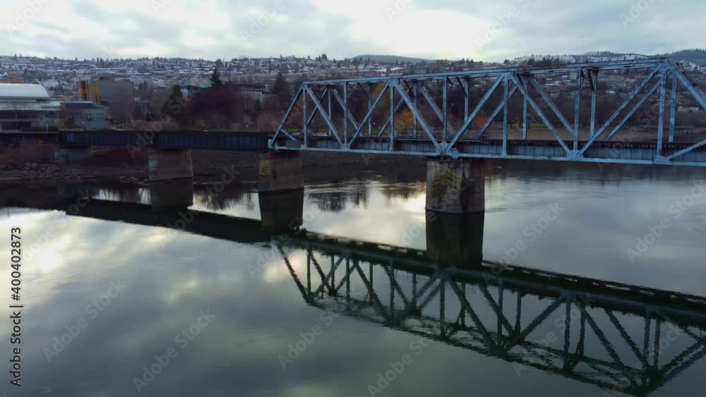 Railway bridge over the river at dawn with mountains in the background. Railway bridge over the river at dawn with mountains in the background.
