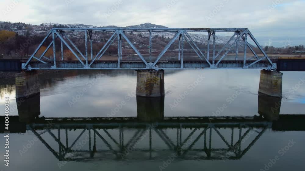 Railway bridge over the river at dawn with mountains in the background. Railway bridge over the river at dawn with mountains in the background.